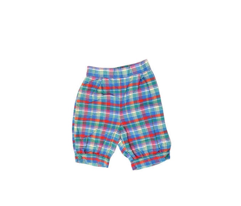 May include: Red, blue, and green plaid shorts with an elastic waistband.