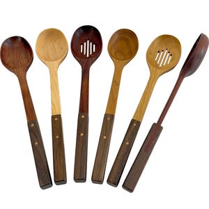 May include: A set of six wooden kitchen spoons and slotted spoons featuring two-toned designs with light and dark wood bowls and dark wood handles secured by two small metal rivets. The collection includes various wood grains and shades of brown.