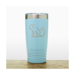 May include: A light blue stainless steel tumbler with a silver lid and a laser-etched design of a stylized monkey.
