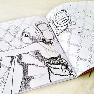 May include: A black and white illustration of a woman with long hair wearing a dress and holding a small animal. The woman is sitting on a patterned floor. The illustration is from a coloring book.