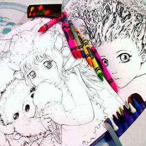 May include: A coloring book open to two pages with illustrations of a girl with a furry animal and a girl with a tree for hair. The pages are surrounded by colorful crayons.