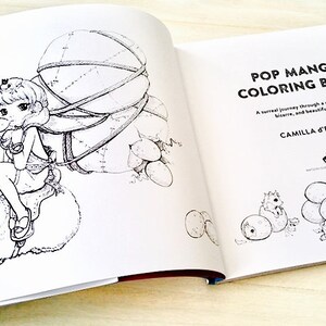 May include: A black and white illustration of a coloring book titled "Pop Manga Coloring Book" by Camilla D'Errico. The book features a surreal journey through a cute, bizarre, and beautiful world.