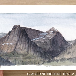 May include: Watercolor painting of a mountain range with a light blue sky. The mountain peaks are brown and gray with some white snow. The mountain range is surrounded by green trees. The text "GLACIER NP HIGHLINE TRAIL 2 (front)" is at the bottom of the image.