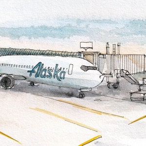 May include: A white aeroplane with the word "Alaska" in blue lettering is parked at a gate. The aeroplane is connected to a jet bridge.