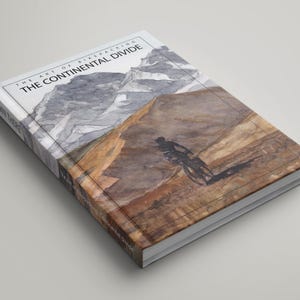 May include: A book cover with a watercolor illustration of a cyclist riding through a mountain landscape. The title of the book is "The Art of Bikepacking: The Continental Divide".