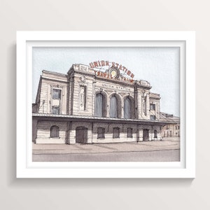 May include: A watercolor illustration of Union Station in Denver, Colorado. The building is a large, ornate structure with a clock tower and a sign that reads "Union Station Travel Train".