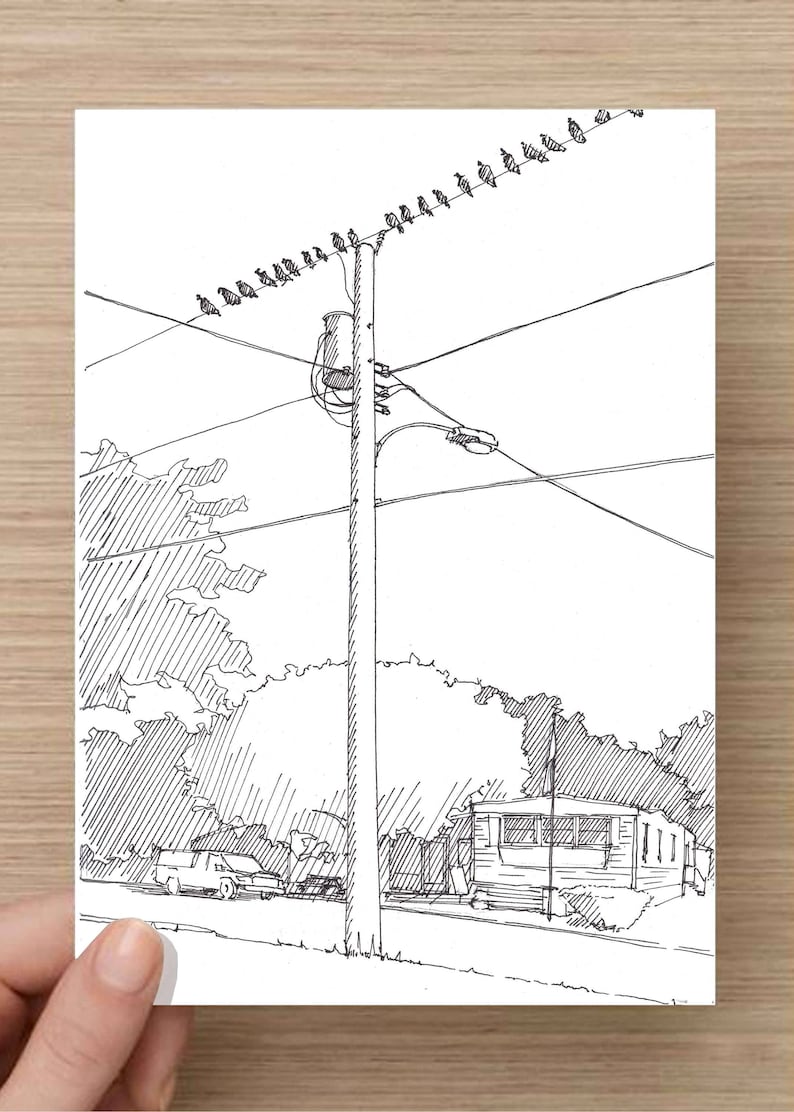 May include: A black and white line drawing of a street scene with a power pole, power lines, a car, a house, and trees.