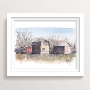 May include: Watercolor painting of three buildings in a rural setting. The buildings are painted in shades of yellow, red, and gray. The sky is a light blue with a few clouds. The painting is framed in a white frame.