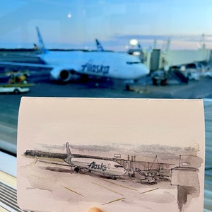 May include: A watercolour painting of an aircraft at an airport gate. The plane is a white and grey Alaska Airlines Boeing 737. The plane is connected to the gate by a jet bridge. The painting is done in a realistic style and captures the details of the plane and the airport.