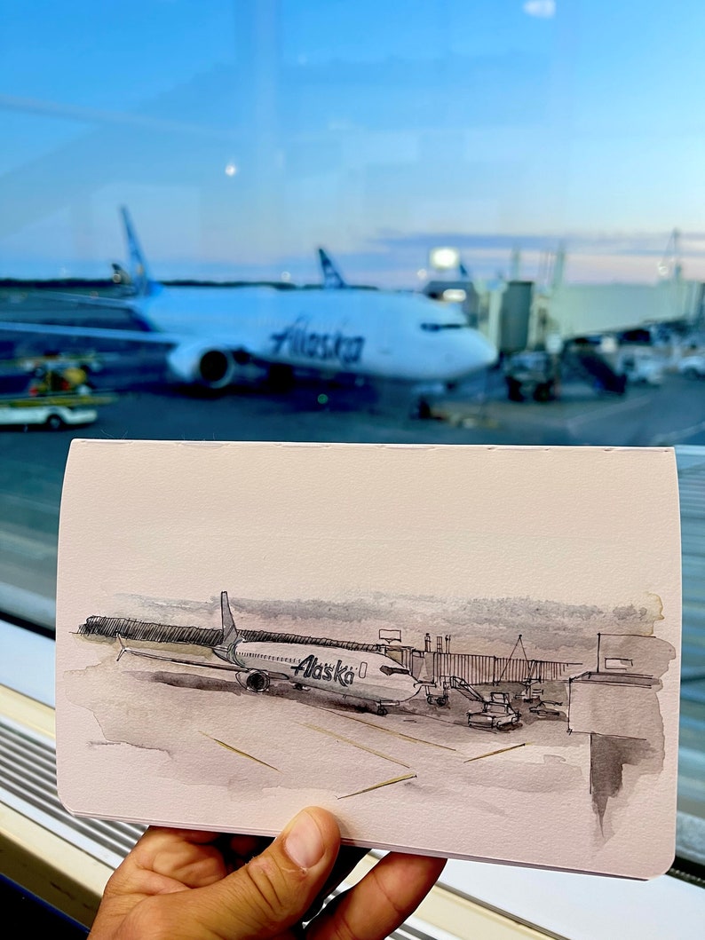 May include: A watercolour painting of an aircraft at an airport gate. The plane is a white and grey Alaska Airlines Boeing 737. The plane is connected to the gate by a jet bridge. The painting is done in a realistic style and captures the details of the plane and the airport.