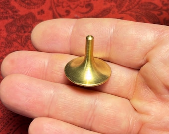 Solid brass spinning top