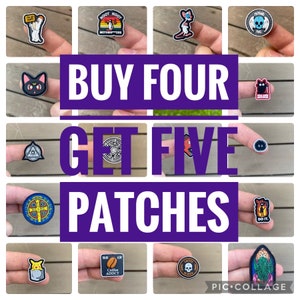 May include: A collage of 10 embroidered iron-on patches with various designs, including a black cat, a skull, a coffee cup, a cartoon character, and a religious symbol. The text "BUY FOUR GET FIVE PATCHES" is written in large purple letters across the center of the collage.