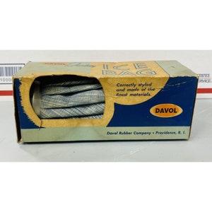 May include: A blue and white patterned ice bag in its original box. The box is blue and white with the text "Davol Ice Bag" and "Correctly styled and made of the finest materials." The box also has the Davol logo and the text "Davol Rubber Company Providence, R. I."