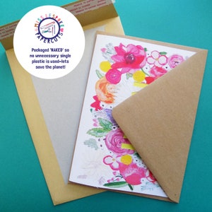 May include: A brown paper envelope with a white card inside. The card has a floral design with pink, yellow, and white flowers. The envelope has the text "Packaged 'NAKED' so no unnecessary single plastic is used-lets save the planet!" printed on it.