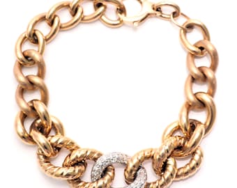 May include: A gold-toned chain bracelet with a lobster clasp. The bracelet features large, rounded links and a central section with textured links and a diamond-studded ring. The bracelet is displayed against a white background.