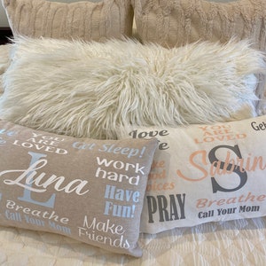 May include: Four decorative throw pillows with inspirational text. The pillows are beige and white with black and blue lettering. The text on the pillows reads: "You are loved", "Get Sleep! Work hard Have Fun! Make Friends", "Love", and "You are loved Sabrina Breathe Call Your Mom".
