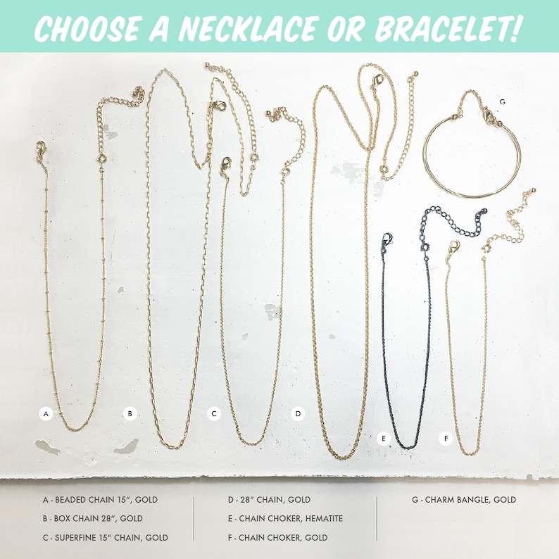 May include: A selection of gold and silver necklaces and a gold bangle bracelet. The necklaces are different lengths and styles, including beaded, box, and superfine chains. The bangle bracelet is a simple, classic design.