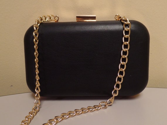 black evening bag with gold chain
