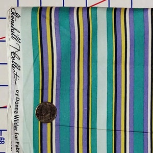 May include: Striped fabric with a teal, purple, yellow, and white color scheme. The fabric has a label that reads "Hanchilli Collection by Donna Wilder for Fabri"