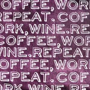 May include: A close-up of a purple fabric with the words "COFFEE, WORK, REPEAT" in a repeating pattern. The text is white with a bold, outlined font. The words "COFFEE, WORK, WINE, REPEAT" are visible.