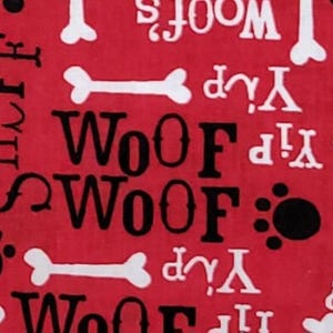May include: Red fabric with a repeating pattern of white dog bones, black and white "Woof" text, paw prints, and the word "Yip". The design is suitable for pet-themed products.