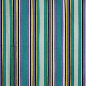 May include: A striped fabric with alternating bands of teal, purple, yellow, white, and black.