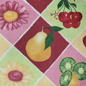 May include: A colorful fabric with a repeating pattern of fruit and flowers. The pattern includes strawberries, cherries, pears, kiwi, and sunflowers. The fabric is in shades of red, pink, yellow, and green.