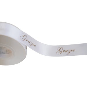 White satin ribbon with handmade THANK YOU written for DIY packaging decoration GRAZIE