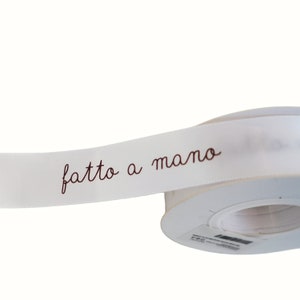 White satin ribbon with handmade THANK YOU written for DIY packaging decoration FATTO A MANO