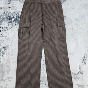 May include: Brown striped cargo pants with a blue label on the waistband.
