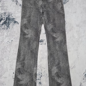 May include: A pair of black and white patterned jeans with a straight leg fit.