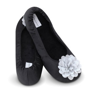 May include: A pair of black satin slippers with a white flower accent. The slippers have a soft, comfortable lining and are perfect for lounging around the house.