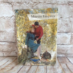 May include: Vintage Martin Emprex stockings package. The image shows a couple in a forest scene. The text "Martin Emprex" and "Stockings" are displayed on the packaging. The package is sealed in plastic.