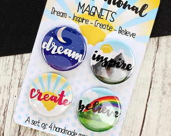 May include: Set of four motivational magnets with colorful designs and inspirational words: dream, inspire, create, and believe. Each magnet features a different background scene and a white, bold font.