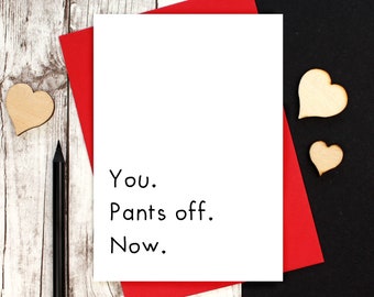 May include: A white card with red text that reads "You. Pants off. Now." The card is on a red envelope and a wooden surface.