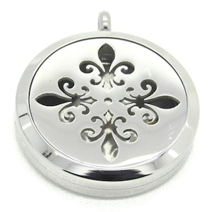 May include: Silver round pendant with a decorative cutout design of four fleur-de-lis.