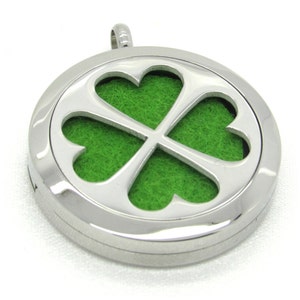May include: A silver round pendant with a four-leaf clover design. The clover is cut out and has a green felt backing.