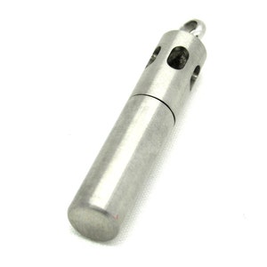 May include: A silver metal tube with a small loop at the top. The tube has a series of small holes around the middle.