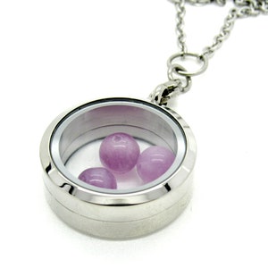 May include: A silver locket necklace with a clear glass insert containing three small purple beads.
