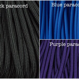 May include: Three spools of paracord in black, blue, and purple. The paracord is a type of rope used for crafting and survival.