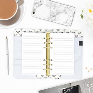 Personal size lined paper planner inserts laid open in a ring binder, gold six-ring mechanism, paired with a marble phone case, coffee mug, and white pen on a styled workspace. Made-to-order by CityGirl Planners. Physical inserts only no binder or accessories included.