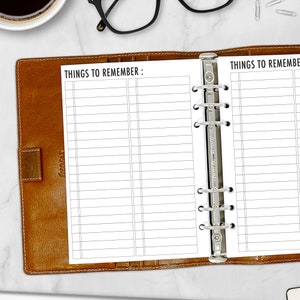 May include: A brown leather planner with a "Things to Remember" list printed on white paper. The planner is open, revealing lined pages for notes. The metal binder rings are visible, along with a coffee cup and eyeglasses in the background.