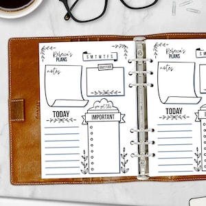 May include: Open brown leather planner with a white paper insert. The insert has sections for notes, daily tasks, and a gratitude section. The text includes "Rebecca's PLANS", "TODAY", "IMPORTANT", and "GRATITUDE".