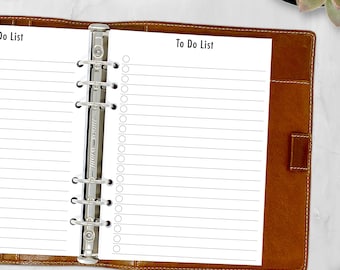 May include: A brown leather bound planner with a silver ring binder. The planner is open to a page with the title "To Do List" and lined paper for writing.