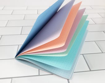 Inserto para cuaderno de viaje con diseño de algodón de azúcar en suaves colores pastel, con variedad de estampados y tamaños.