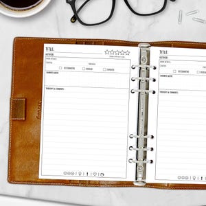 May include: A white book planner with a brown leather cover. The planner has a section for book titles, authors, and ratings. It also has sections for book details, favorite quotes, and thoughts and comments.