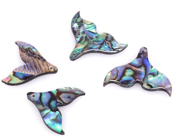 May include: Four iridescent abalone shell mermaid tail charms. The charms are a light blue, green, and purple color with a black outline.