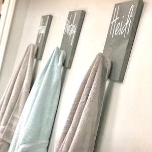 a row of towels hanging on a wall