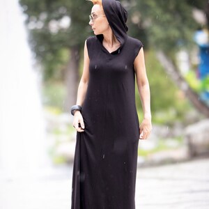 Model wearing long casual hoodie dress with pockets