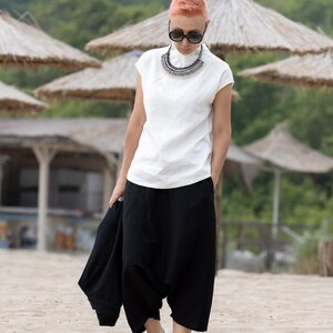 Model wearing structured black summer top with clean lines